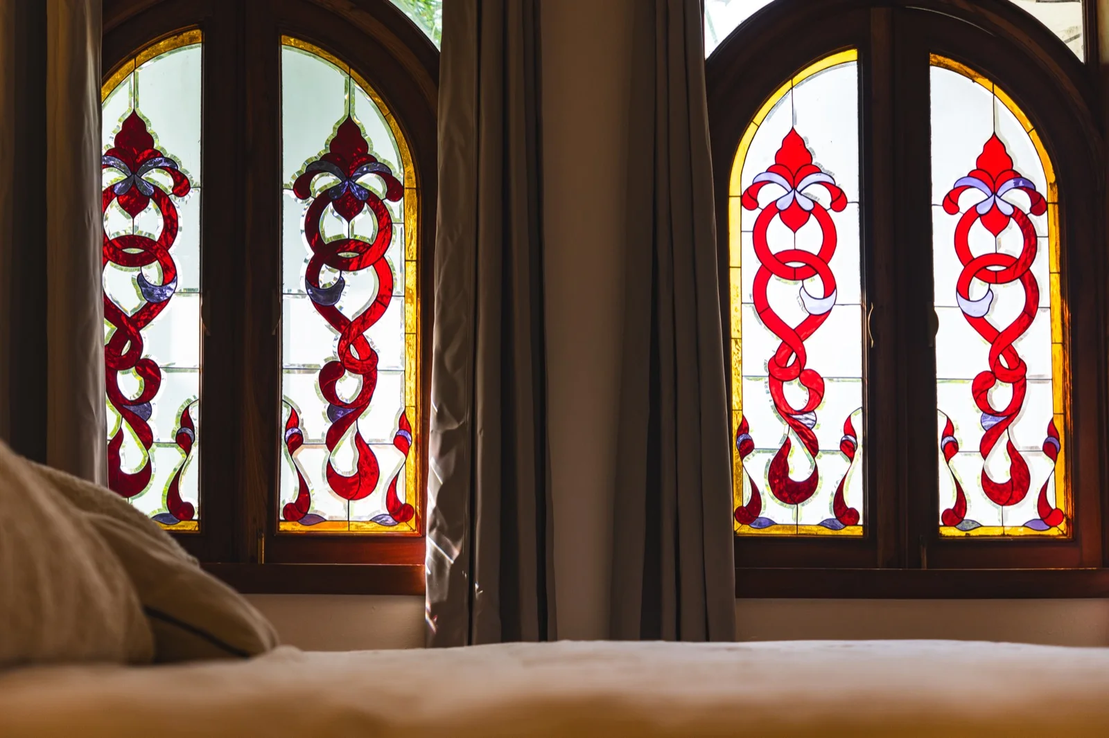 Stained glass arched windows in master bedroom