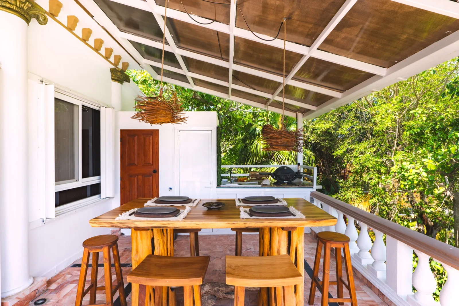 Shaded terrace dining with jungle view