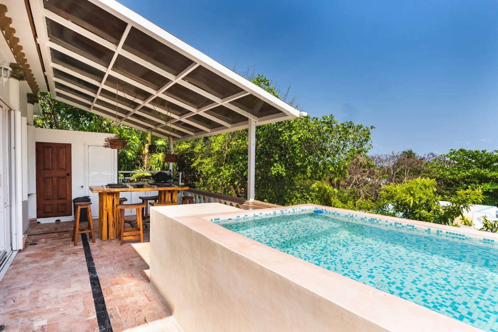 Rooftop pool with jungle view and terrace dining