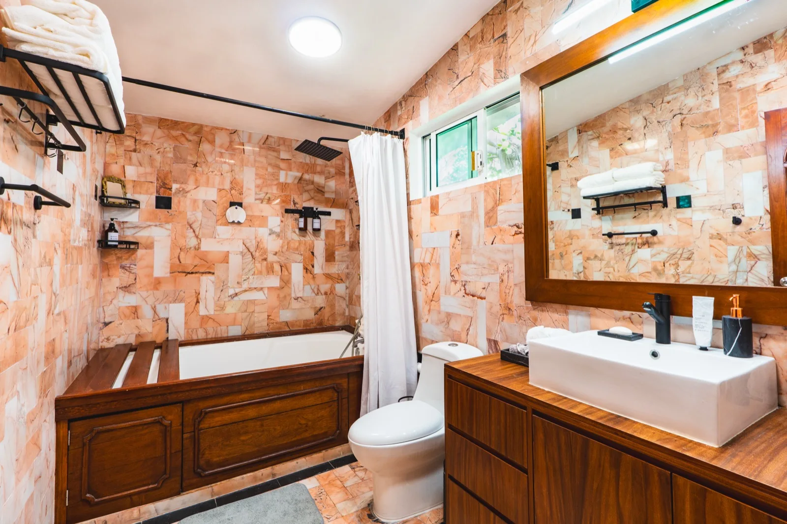 Bathroom with terracotta marble and wood tub